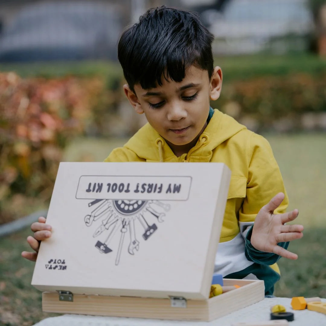 Child excitedly opening the Wooden Tool Kit Toy toolbox, discovering 40 safe and colorful wooden tools inside