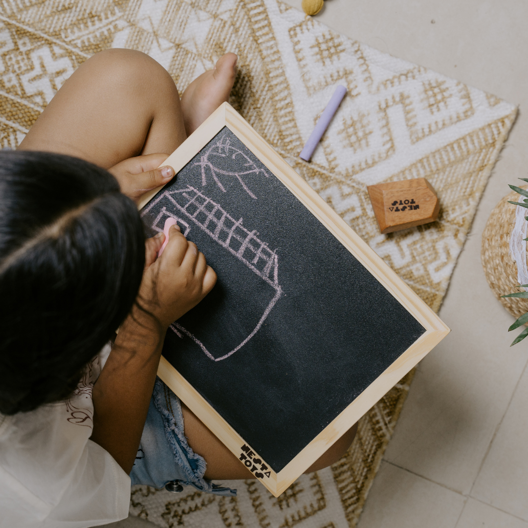 Kid drawing and writing on wooden chalkboard slate from NESTA TOYS