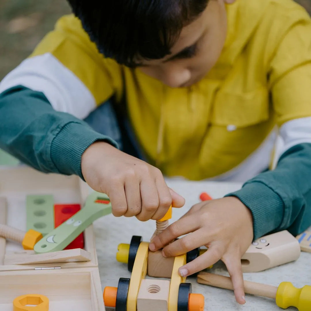NESTA TOYS – Wooden Activity Tool Kit Toy for Kids, Kid assembling and using wooden tools from the Wooden Tool Kit Toy, enjoying safe and imaginative play