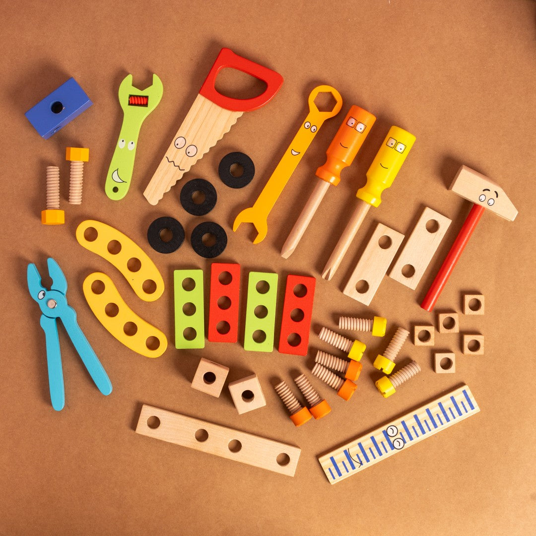NESTA TOYS – Wooden Pretend Play Tool Set for Kids Colorful toy tools and hardware items on a brown background
