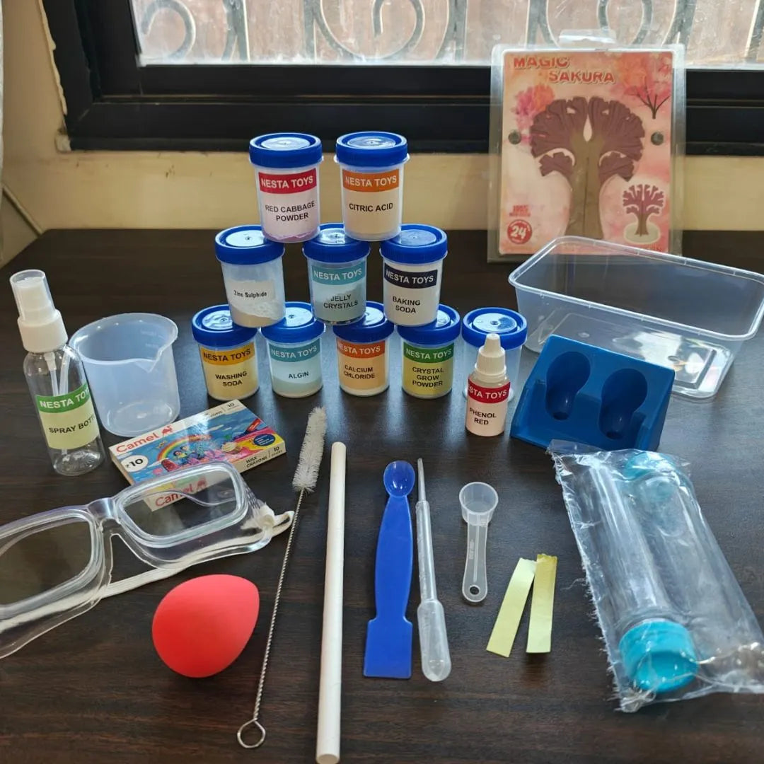 Kids chemistry lab kit with colorful experiment bottles, safety goggles, measuring tools, test tubes, and science accessories neatly arranged on a table for hands-on learning experiments.