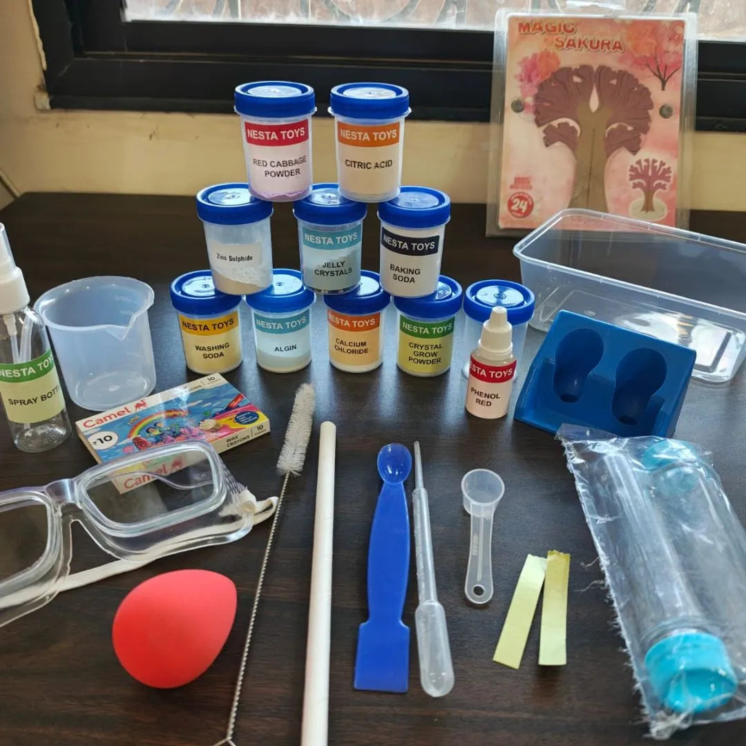 Kids chemistry lab kit with colorful experiment bottles, safety goggles, measuring tools, test tubes, and science accessories neatly arranged on a table for hands-on learning experiments.