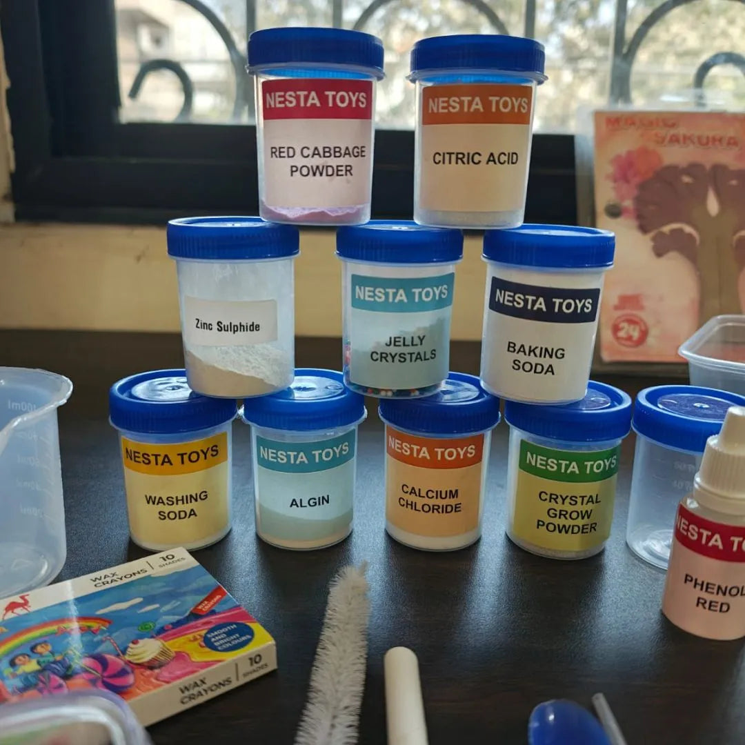 Kids chemistry lab kit with colorful experiment bottles, safety goggles, measuring tools, test tubes, and science accessories neatly arranged on a table for hands-on learning experiments.